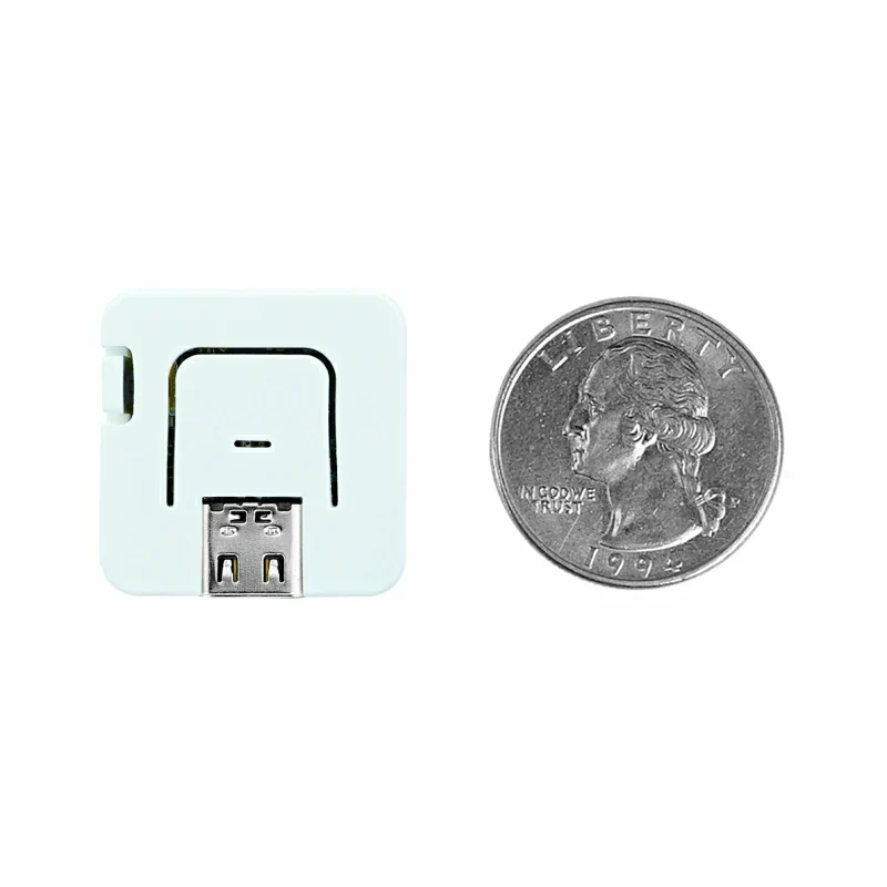 M5Stack AtomS3 Lite beside a quarter — smaller than a coin